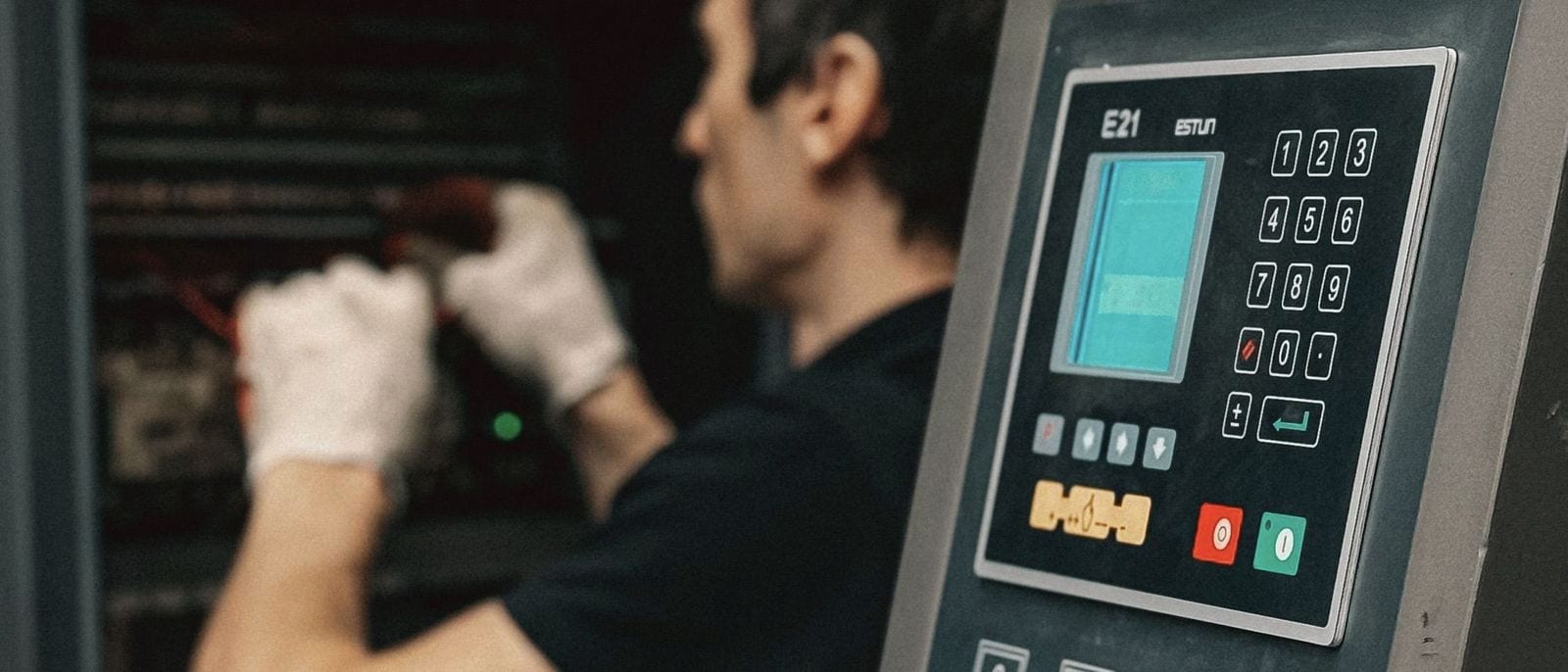 Technician working inside an open control cabinet